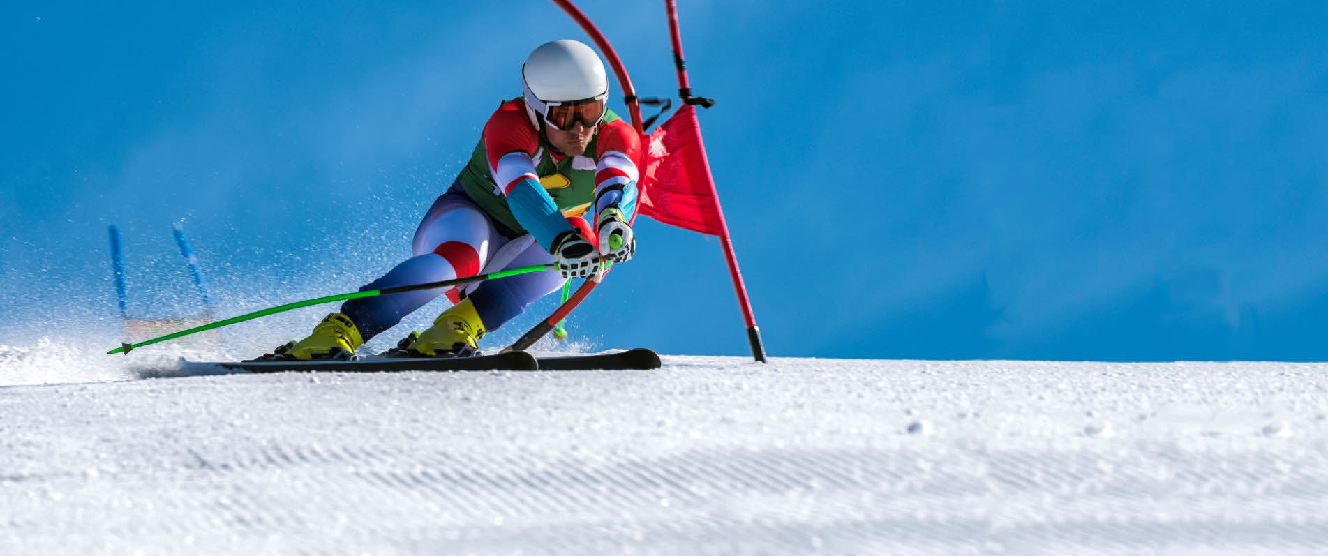 male slalom racer turning past gate